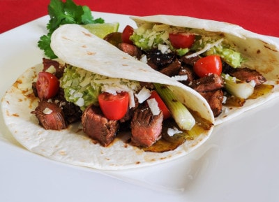 Steak, Anaheim Chile, and Scallion Tacos with Guacamole and Cotija Cheese