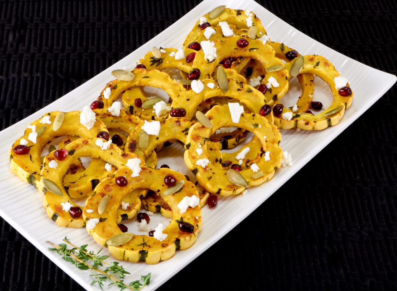 Herb Roasted Delicata Squash Topped with Pomegranate Seeds, Pepitas, and Feta
