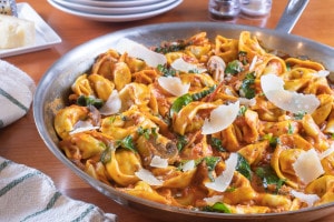 Italian Sausage Tortellini Skillet with Mushrooms and Spinach in a Creamy Tomato Sauce