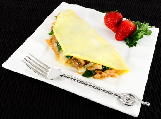 Thin Omelet with Caramelized Onions, Sautéed Mushrooms, Ham, Spinach, and Brie